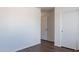 Simple bedroom with double door closet and dark brown laminate flooring at 285 W Santa Gertrudis Trl, San Tan Valley, AZ 85143