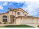 Tan two-story house with a three-car garage and solar panels at 15954 N 162Nd Ln, Surprise, AZ 85374