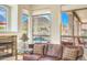 Gathering room with stone fireplace and windows overlooking the backyard and pool at 11377 E Diamond Cholla Dr, Scottsdale, AZ 85255