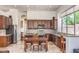 Spacious kitchen featuring dark wood cabinets, granite countertops, and stainless steel appliances at 11377 E Diamond Cholla Dr, Scottsdale, AZ 85255