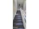 Modern dark-wood stairs with white railings leading upstairs at 639 W Pepper Pl # 109, Mesa, AZ 85201