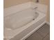 Clean bathtub with gray tile flooring at 639 W Pepper Pl # 102, Mesa, AZ 85201