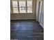 Well-lit bedroom with large windows and gray flooring at 639 W Pepper Pl # 102, Mesa, AZ 85201