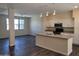 Modern kitchen with white cabinets, island, and stainless steel appliances at 639 W Pepper Pl # 102, Mesa, AZ 85201