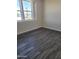 Bedroom with large window and gray flooring at 639 W Pepper Pl # 102, Mesa, AZ 85201