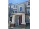 Townhome entrance with modern brown door and columns at 639 W Pepper Pl # 102, Mesa, AZ 85201