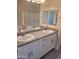 Double vanity bathroom with modern white cabinets at 639 W Pepper Pl # 102, Mesa, AZ 85201