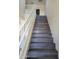 Modern staircase with wood-look laminate treads and white railing at 639 W Pepper Pl # 102, Mesa, AZ 85201