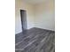 Simple bedroom with gray flooring and access to bathroom at 639 W Pepper Pl # 102, Mesa, AZ 85201