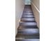 Modern stairs with dark wood-look flooring and lighting at 639 W Pepper Pl # 107, Mesa, AZ 85201