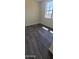Bright bedroom with dark gray wood-look floors at 639 W Pepper Pl # 107, Mesa, AZ 85201