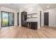 Modern wet bar with dark cabinetry, wine cooler, and floating shelves at 3014 E Avalon Dr, Phoenix, AZ 85016