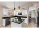 Kitchen with granite countertops, white cabinets, and island at 3817 E Irma Ln, Phoenix, AZ 85050