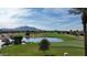 Aerial view of a beautiful golf course community with a lake and mountain backdrop at 6574 S Crestview Dr, Gilbert, AZ 85298