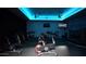 Modern spin studio with multiple exercise bikes and blue accent lighting at 6574 S Crestview Dr, Gilbert, AZ 85298