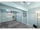 Light teal bedroom with grey carpet, ceiling fan, and barn door at 710 W 18Th St, Tempe, AZ 85281