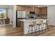 Modern kitchen with island, stainless steel appliances, and light wood cabinets at 24367 W Jessica Ln, Buckeye, AZ 85326
