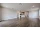 Open concept living area with wood-look tile flooring and view of the kitchen at 40065 W Bravo Dr, Maricopa, AZ 85138