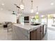 Modern kitchen with a large island, marble countertops, and pendant lighting at 7740 E Rose Ln, Scottsdale, AZ 85250