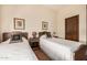 Two twin beds with antique frames in a guest bedroom at 4755 S Pura Vida Way, Gold Canyon, AZ 85118