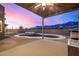 Kidney shaped pool and spa with sunset view at 4755 S Pura Vida Way, Gold Canyon, AZ 85118