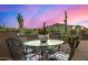 Patio furniture with mountain view; sunset in background at 4755 S Pura Vida Way, Gold Canyon, AZ 85118