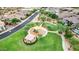 An aerial view of a neighborhood playground with play equipment and shaded seating areas at 9844 E June St, Mesa, AZ 85207