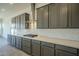 Modern kitchen with gray shaker cabinets, quartz counters, and white tile backsplash at 274 S 164Th Dr, Goodyear, AZ 85338