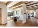 Bright dining area with wooden beams, a round table and chairs, and views of the pool and desert landscape at 23832 N 112Th Pl, Scottsdale, AZ 85255