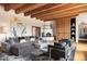 Spacious living room featuring a cozy fireplace, hardwood floors, and large windows at 23832 N 112Th Pl, Scottsdale, AZ 85255