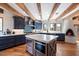 Spacious kitchen with island, blue cabinets and wood beams at 23832 N 112Th Pl, Scottsdale, AZ 85255