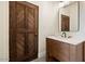 Modern bathroom with a floating vanity and a statement chevron wood door at 23832 N 112Th Pl, Scottsdale, AZ 85255