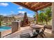 Relaxing patio with a stone fireplace, hot tub, and mountain views at 23832 N 112Th Pl, Scottsdale, AZ 85255