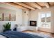 Main bedroom with fireplace, window seat, and wood beam ceiling at 23832 N 112Th Pl, Scottsdale, AZ 85255