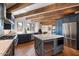 Modern kitchen with blue cabinetry, island, and a fireplace at 23832 N 112Th Pl, Scottsdale, AZ 85255