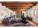 Living room with hardwood floors, sectional sofa, and wood beam ceilings at 23832 N 112Th Pl, Scottsdale, AZ 85255