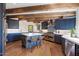 Modern kitchen with blue cabinetry, an island, and wood beams at 23832 N 112Th Pl, Scottsdale, AZ 85255