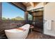 Bathroom with soaking tub, walk-in shower, and mountain views at 23832 N 112Th Pl, Scottsdale, AZ 85255