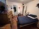 Second bedroom with a twin bed, dresser, and wood-look floors at 6321 N 65Th Dr, Glendale, AZ 85301