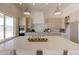 Large kitchen island with quartz countertops and a farmhouse sink at 6828 N 177Th Pl, Waddell, AZ 85355