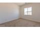 Spacious bedroom with neutral carpeting and large window at 6828 N 177Th Pl, Waddell, AZ 85355