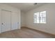 Bright bedroom featuring light wood floors and neutral walls at 6828 N 177Th Pl, Waddell, AZ 85355