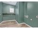 Laundry room with green walls and wood shelving at 20977 E Macaw Dr, Queen Creek, AZ 85142