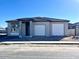 Single-story home with a three-car garage and a modern exterior at 22701 E Lords Way, Queen Creek, AZ 85142