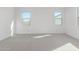 Spacious bedroom with two large windows and neutral decor at 17975 W Vogel Ave, Goodyear, AZ 85338
