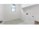 Laundry room with overhead shelving, a utility sink and window at 17975 W Vogel Ave, Goodyear, AZ 85338