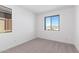 Bright bedroom with neutral carpeting and large window at 17975 W Vogel Ave, Goodyear, AZ 85338
