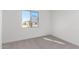 Bright bedroom with carpeted floors and a window offering natural light at 17975 W Vogel Ave, Goodyear, AZ 85338