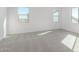 Bright and airy bedroom with two windows and carpeted floors at 17975 W Vogel Ave, Goodyear, AZ 85338