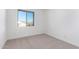 Well-lit bedroom featuring neutral walls and carpet at 17975 W Vogel Ave, Goodyear, AZ 85338